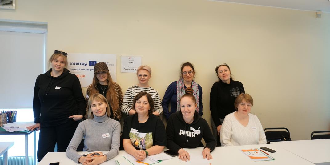 People posing behind a table 