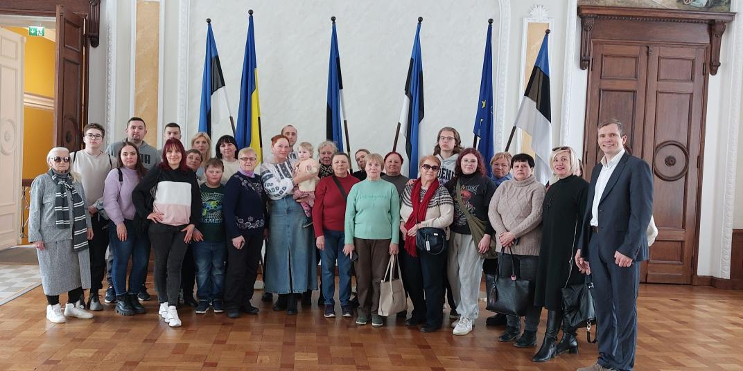 People standing infront of flags