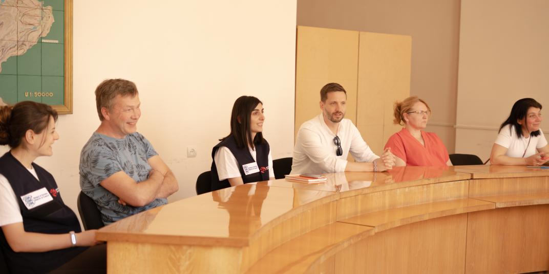 People sitting at a table discussing 
