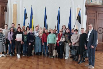 People standing infront of flags