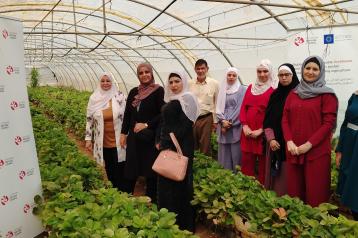 Women standing in a hydroponic greenhouse 