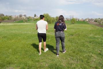 Alina, participant of the programme, shows ERC team a pasture