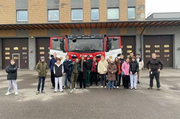 refugee youth infront of a firetruck 