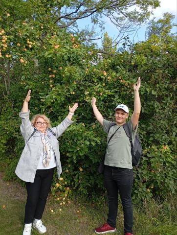 Two people standing arms raised